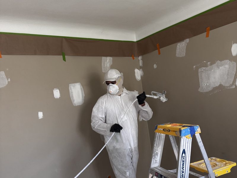 Repaired and coated drywall surface