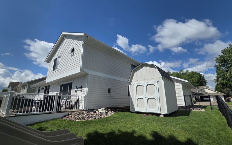 Completed exterior repaint on a white Minnesota home