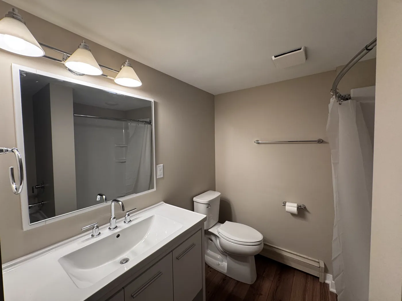 Bathroom vanity refinished in gray paint with a new quartz countertop