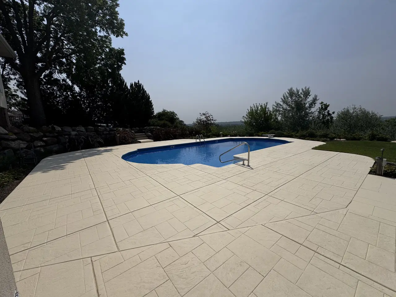 Poolside stamped concrete patio at a project property